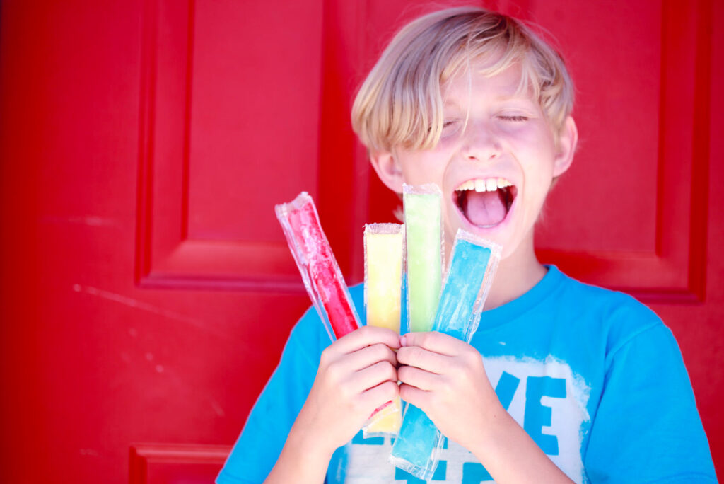 child holding a popsicle stick